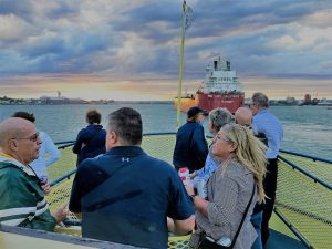 Sip and Sail tour in the evening with large freighter going by.
